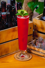 Beautiful bright cocktail on a brown wooden table. Summer refreshing drink.
