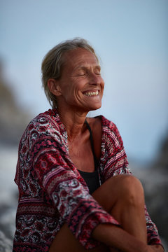 Smiling woman with eyes closed