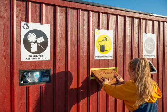 Girl putting rubbish into recycling bin