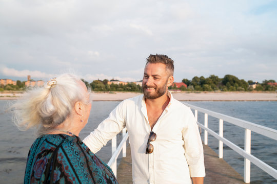 Man with senior mother at seaside