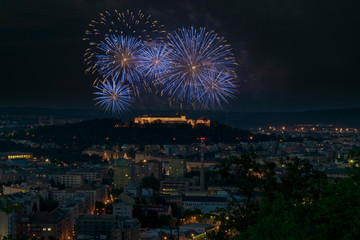 Brno Spilberk blue pyrotechnics brunensis. Year fireworks ignis celebration. Night sparkling city with illuminating buildings and castle Spilberg with dark sky on background.