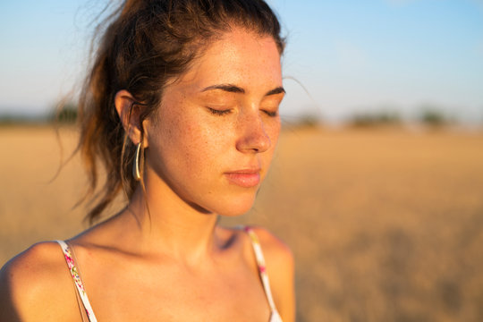 Young woman with eyes closed