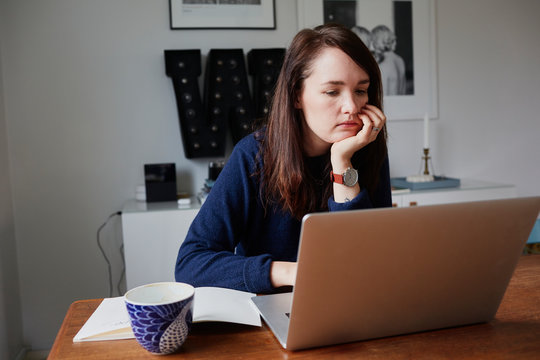 Young woman using laptop at home