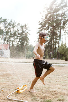 Cheerful boy playing with water