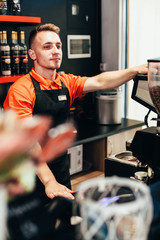 Barista makes delicious coffee in a coffee shop