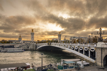 Paris, France - November 24, 2019: Stunning Pont Alexandre III bridge (1896) spanning the river Seine. Decorated with ornate Art Nouveau lamps and sculptures it is the most extravagant bridge in Paris
