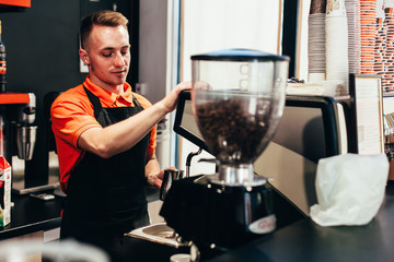 Barista makes delicious coffee in a coffee shop