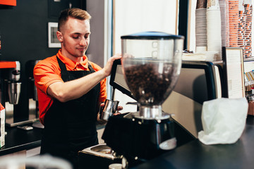 Barista makes delicious coffee in a coffee shop