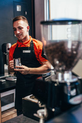 Barista makes delicious coffee in a coffee shop