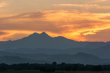 Sunset behind Rocky Mountains range in hazy conditions