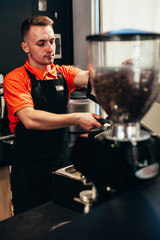 Barista makes delicious coffee in a coffee shop