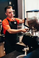 Barista makes delicious coffee in a coffee shop