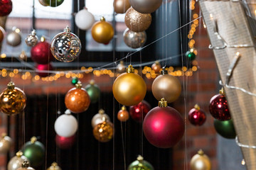 Creative festive composition with string on blurred background.Winter concept. Christmas tree decorations, colorful balls.Christmas baubles.Cafe, Restaurant,Street decorations.Happy new year