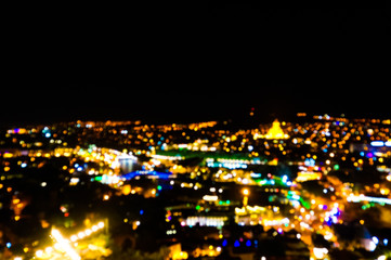 Blurred background bokeh multicolored city night lights. Panoramic view of the capital of Georgia Tbilisi