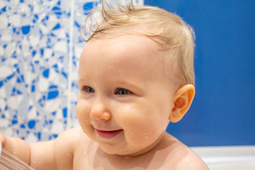 Child plays with a shower in the bathroom
