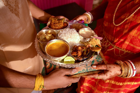 Newly Married Husband And Wife Exchanging Traditional Indian Food Thali After Marriage , A Traditional Bengali Wedding Rituals In West Bengal Or Bangladesh.