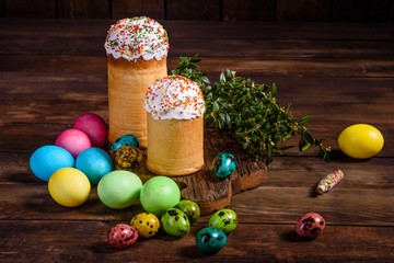 Easter cake and colorful eggs on a dark background
