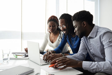 Black afro friends studying home.