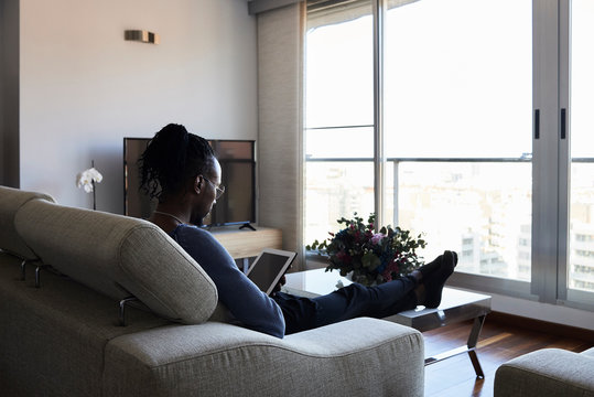 Reading e-book at home.