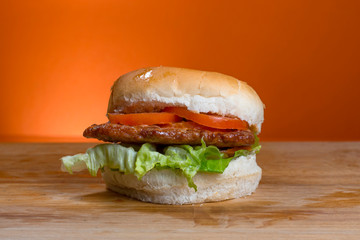 Take-Away foods on Orange vibrant background colour and wood