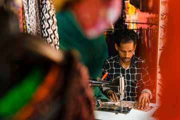 Ethnic tailor in workshop