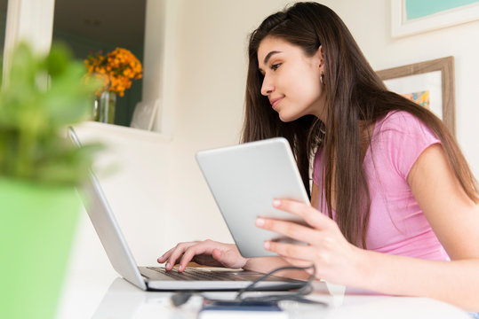 Teenage girl working on laptop