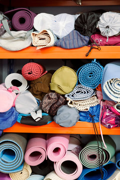 Yoga mats on shelves in gym