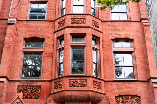 Vibrant red bricks line a bay window of an apartment building in new york city