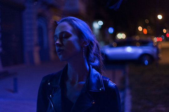portrait of a girl in a leather jacket in neon light cyberpunk
