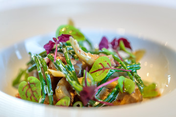 Closeup shot of a healthy vegetable salad in a white ceramic bowl