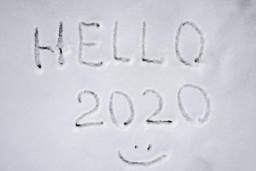  In the snow the inscription "Hello 2020" and smiley face