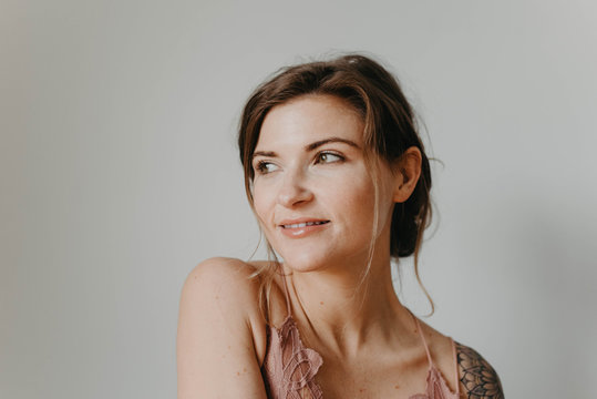 Studio portraits of a beautiful woman in her twenties with tattoos