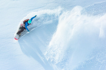 Snowboarder riding on fresh snow