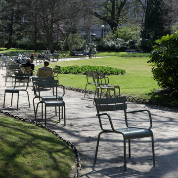 Locals Enjoying Springtime In A Parisian Garden