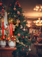 Christmas red candles on a background of decorated spruce for the holiday