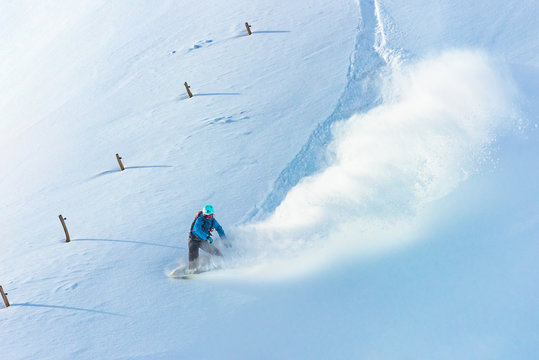 Snowboarder riding on fresh snow