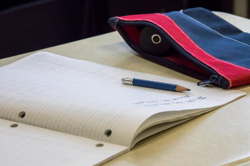 Kids learning and writing in school.