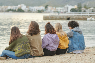 Relaxed group of teens on the beach.