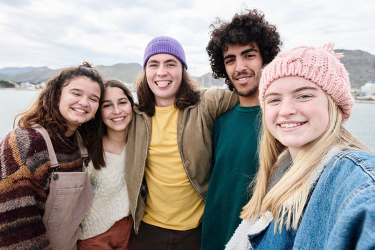 Positivity teens taking photo together on lake.