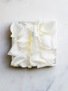 Beauty oil bottle on rose petals