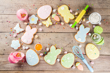 Happy easter background with pastel colored easter cookies - bunnies, eggs, flower, butterfly, Wooden rustic background, flatlay banner copy space