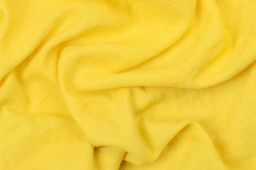 close up crumpled yellow cotton fabric background