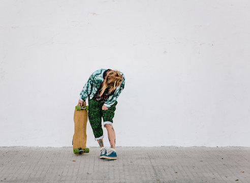 Woman standing with longboard