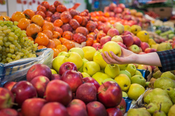 Caucasian girl buying fresh vegetables food products at the market