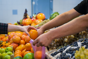 Woman buying fresh vegetables at street market.