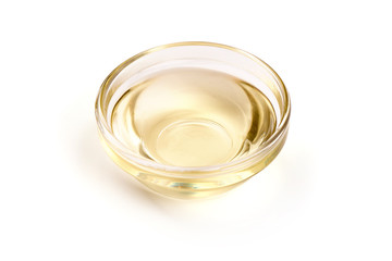Vegetable oil in a bowl, isolated on white background