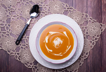 Closeup on a carrot cream-soup with heavy cream