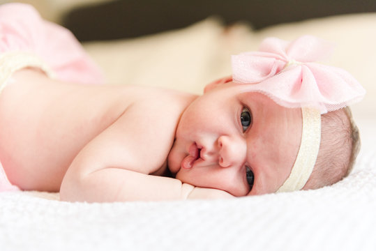 Portrait of newborn baby girl posing for photo