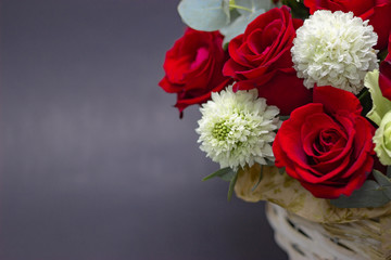 red roses on a dark background composition of red roses in a basket
