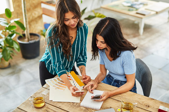 Two young woman at an informal work meeting
